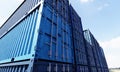 Stack of blue container boxes with sky background. Cargo freight shipping for import and export logistics. Business and Royalty Free Stock Photo