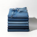 Stack of blue denim jeans folded on a white background studio shot Royalty Free Stock Photo