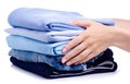 Stack blue folded clothing in hand