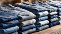 Stack of blue and grey denim jeans on wooden table in store display Royalty Free Stock Photo
