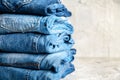 Stack of blue jeans on a gray background Royalty Free Stock Photo