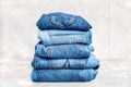 Stack of blue jeans on a gray background Royalty Free Stock Photo