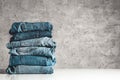 Stack of blue jeans on a gray background Royalty Free Stock Photo