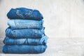 Stack of blue jeans on a gray background Royalty Free Stock Photo