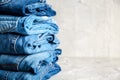 Stack of blue jeans on a gray background Royalty Free Stock Photo
