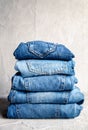 Stack of blue jeans on a gray background Royalty Free Stock Photo