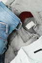 Stack of blue jeans, shirts. Second hand clothing shop Royalty Free Stock Photo