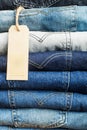 Stack of blue jeans in various shades. tag for an inscription Royalty Free Stock Photo