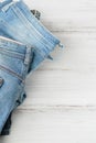 Stack of blue jeans on white background. Second hand clothing shop