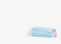 A stack of blue medical masks on a white background. Protection and prevention against coronavirus, covid-19 and other viruses. Royalty Free Stock Photo