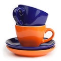 Stack of blue and orange tea cups and saucers Royalty Free Stock Photo