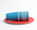 Stack of blue paper cups and red round plates on a white background Royalty Free Stock Photo