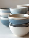A stack of blue and white ceramic bowls on a white surface. Royalty Free Stock Photo