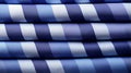 A stack of blue and white striped fabric Royalty Free Stock Photo