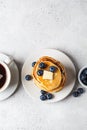 Stack of blueberry pancakes with maple syrup and butter on white breakfast plate Royalty Free Stock Photo