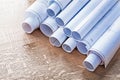 Stack of blueprint rolls on wood oaken board Royalty Free Stock Photo