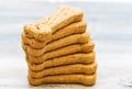 Stack of Bone shaped dog biscuits of brown color. Dog food used for training Royalty Free Stock Photo