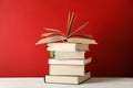 Stack of books against red background Royalty Free Stock Photo