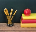 Stack of books with apple and pencils Royalty Free Stock Photo