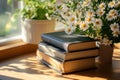 Stack of books with blooming spring flowers in sunlight Royalty Free Stock Photo