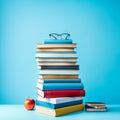 Stack of books on blue background. Education concept. AI generated Royalty Free Stock Photo