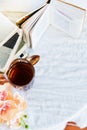 a stack of books, a book and tea in a glass Cup on bright background with branch of Orchid, the concept of love of reading, time t Royalty Free Stock Photo