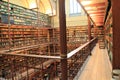 Stack of books on bookshelf inside library.