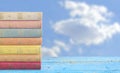 Stack of books on cloudy blue sky background,copy space Royalty Free Stock Photo