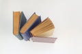 Stack of books in colour covers with white sheets isolated on a white background Royalty Free Stock Photo