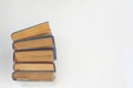 Stack of books in colour covers with white sheets isolated on a white background Royalty Free Stock Photo