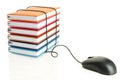 Stack of books connecting to a computer mouse Royalty Free Stock Photo