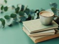 A stack of books and a cup of coffee on a table Royalty Free Stock Photo