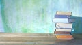 Stack of books on green grungy background,good copy