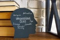 A stack of books and a head with an inscription unconscious bias. Royalty Free Stock Photo