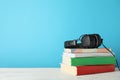 Stack of books and headphones on wooden table Royalty Free Stock Photo