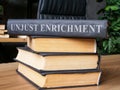 Stack of books with a law about unjust enrichment on it.