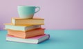 Stack of books on a light blue table with a pastel lavender background Royalty Free Stock Photo