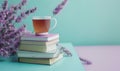 Stack of books on a light blue table with a pastel lavender background Royalty Free Stock Photo