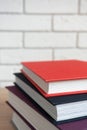 A stack of books with multi-colored covers on the table with blurred background Royalty Free Stock Photo