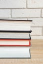 Stack of books in multi-colored covers on a wooden table Royalty Free Stock Photo