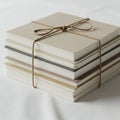 A stack of books is neatly tied with a brown string, forming a square bundle. The Royalty Free Stock Photo
