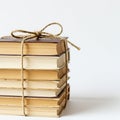 A stack of books is neatly tied together with rustic twine, creating a symmetrical bundle. Royalty Free Stock Photo