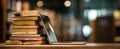 The stack of books next to a modern laptop in a cozy library setting..AI generated image Royalty Free Stock Photo