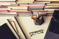 Stack of books, notebook, laptop, glasses in office background for education learning concept top view Royalty Free Stock Photo