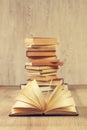 One open book and a stack of books Royalty Free Stock Photo