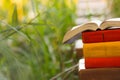 Stack of books and Open hardback book on blurred Royalty Free Stock Photo