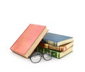 Stack of books with a pair of eyeglasses.