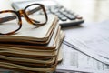 A stack of books with a pair of glasses placed on top, depicting a study or reading scene, Ledger books stacked up with a Royalty Free Stock Photo