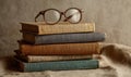 A stack of books with a pair of glasses on top Royalty Free Stock Photo