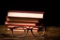 Stack of books with a pair of glasses Royalty Free Stock Photo